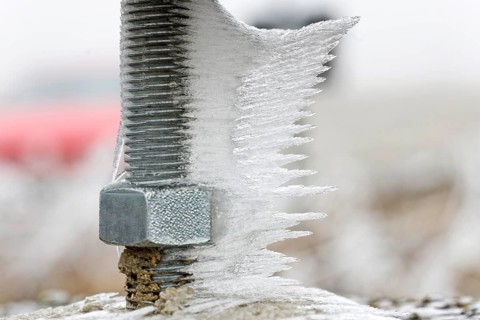 Hoarfrost and ice on a threaded screw
