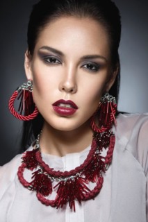 Beautiful fashionable girl with smooth hair and original decoration around her neck
