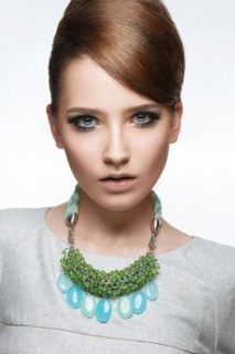 Beautiful fashionable girl with smooth hair and original decoration around her neck