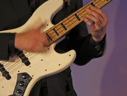 Jazz bassist slaps an electric bass
