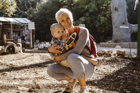 Mother hugging her two years old son wuth an airplane in Cedre Gouraud Forest in Azrou
