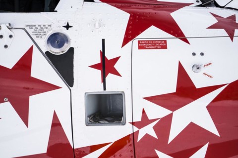 Swiss helicopter close up side view with red and white stars on chassis