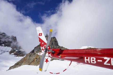 Swiss helicopter tail close up side view with red and white stars on chassis
