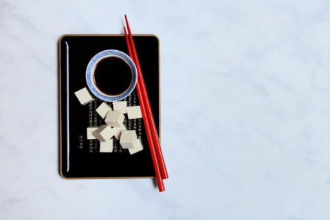 Tofu cubes and soy sauce on tray