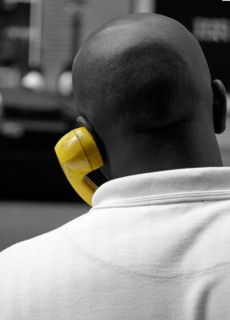 African American man talking on yellow phone