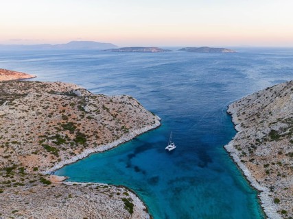Sailing catamaran in a bay of Levitha Island