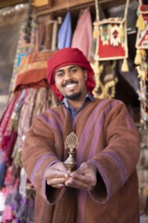 Jordanian Bedouin with traditional eyeliner shows a bronze vial with AlKuhl