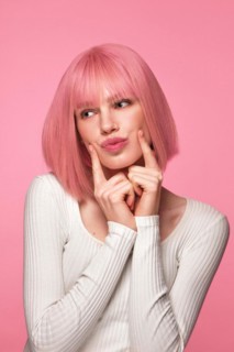 Beautiful funny cute woman in pink wig and classic makeup