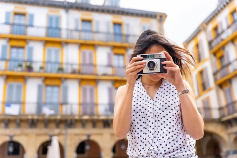 Tourist woman enjoying visiting the city looking at travel photos