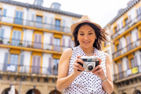 Tourist woman visiting the city looking at travel photos