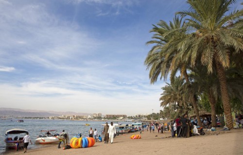 Jordanians and palm trees on the beach