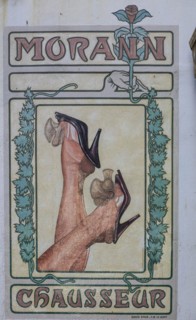 Painted logo Art Nouveau shoe shop on a house facade