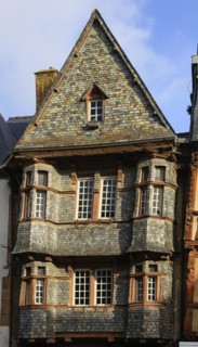 Half-timbered house clad in slate on the Place du General Leclerc