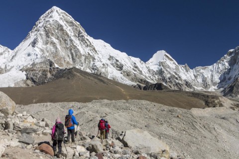 Trekkers crossing the glacier moraines en-route of the Everest Base Camp trek