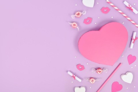 Pastel colored Valentine's Day flat lay with heart shaped gift box