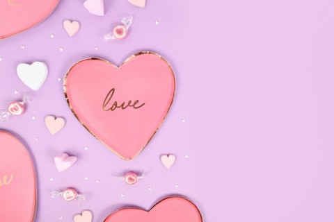 Pastel colored Valentine's Day flat lay with heart shaped plates