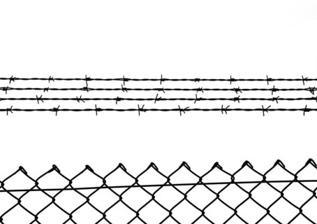 Chain link fence with additional barbed wire