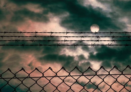 Chain link fence with additional barbed wire