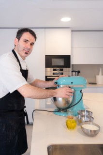 A man baker bakes a red velvet cake at home