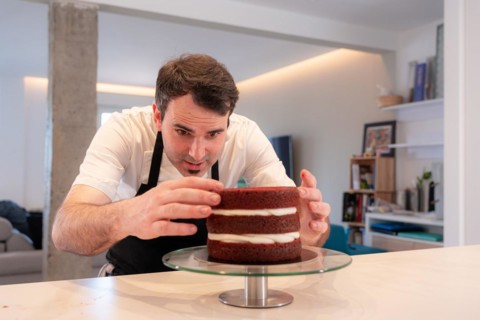 A challenger man bakes a red velvet cake at home