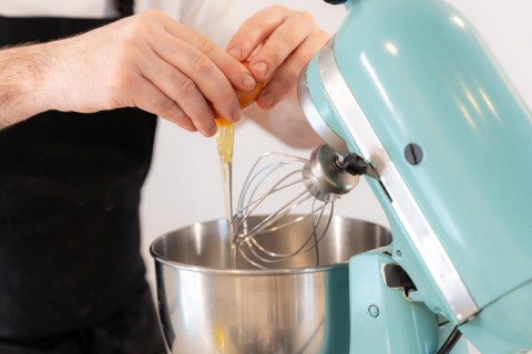 A man baker cooking a red velvet cake at home