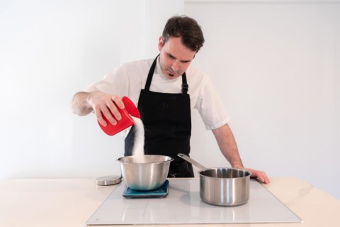 Hands of a man cooking a red velvet cake at home