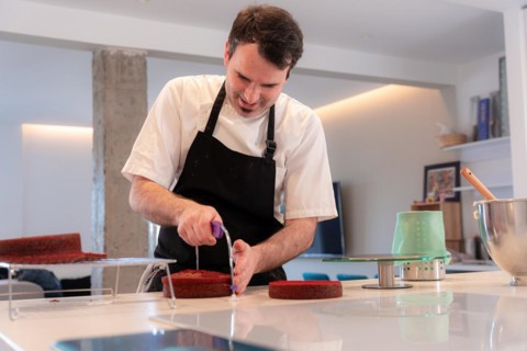 A challenger man bakes a red velvet cake at home