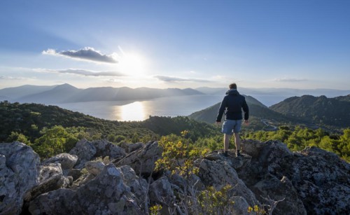 Hiker looking over volcanic peninsula Methana