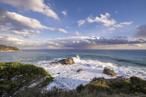 Landscape of stones and sea on the Costa Brava in Girona in Spain at sunset on a winter afternoon
