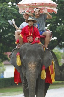 Thai men riding an elephant