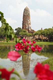 Prang of Wat Phra Ram reflected in the park lake