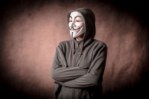 Man wearing anonymous mask with sweatshirt