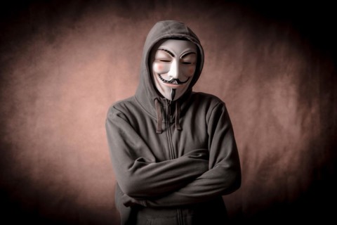 Man wearing anonymous mask with sweatshirt