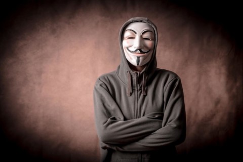 Man with anonymous mask with sweatshirt