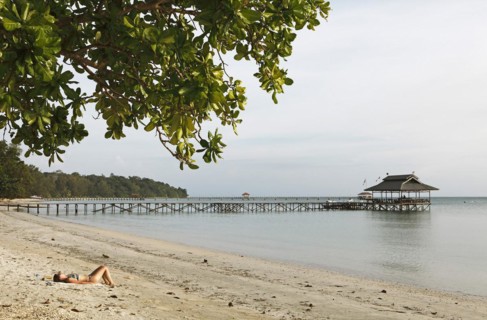 Beach and jetty on Pulau Tiga Island or Survivor Island