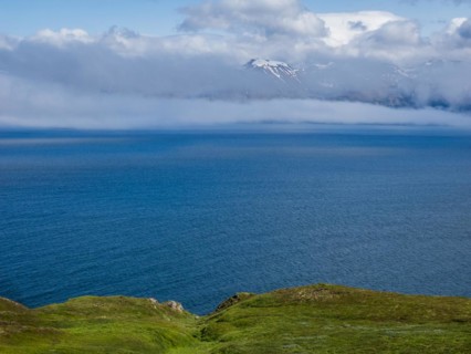 View over Eyjafoerour to the snow-capped mountains near Dalvik