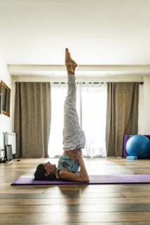 Side view of a woman practicing yoga