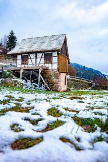 Water mill in snow and ice in winter