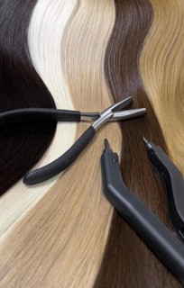 Strands of natural hair in different colors for extensions with tools