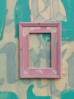 Weathered picture frame on a wooden wall