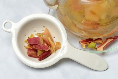 Apple peel tea in teapot and apple peel in tea strainer