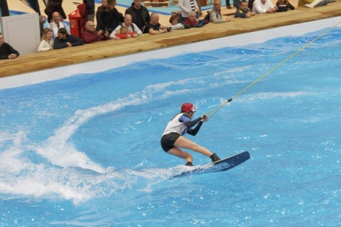 Wakeboarder glides over water