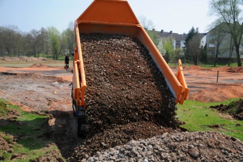 Truck dumps stones and building rubble