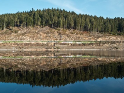 Reflection of the shore enclosure of the Schluchsee
