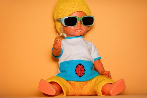 Cool doll with sunglasses and yellow knitted cap