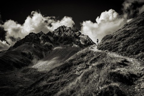 Mountain path with climber in the background Peak of Piz Kesch