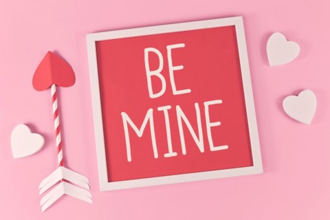 Valentines Day composition with picture frame with text Be Mine
