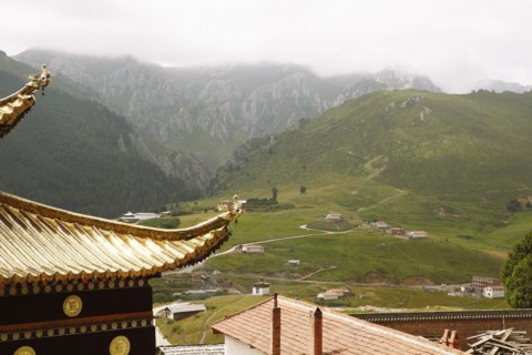 Golden temple roofs and green valleys in the mountain landscape