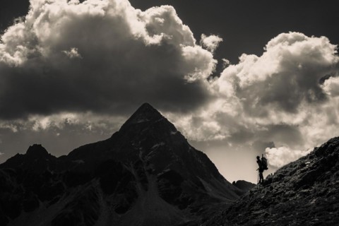 Striking peak of Piz OT with climber in the backlight