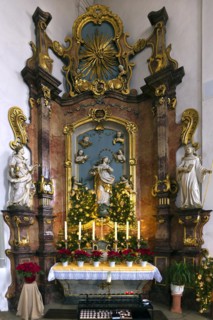 Altar of the Virgin Mary in the late Baroque St Bartholomews Church decorated for Christmas